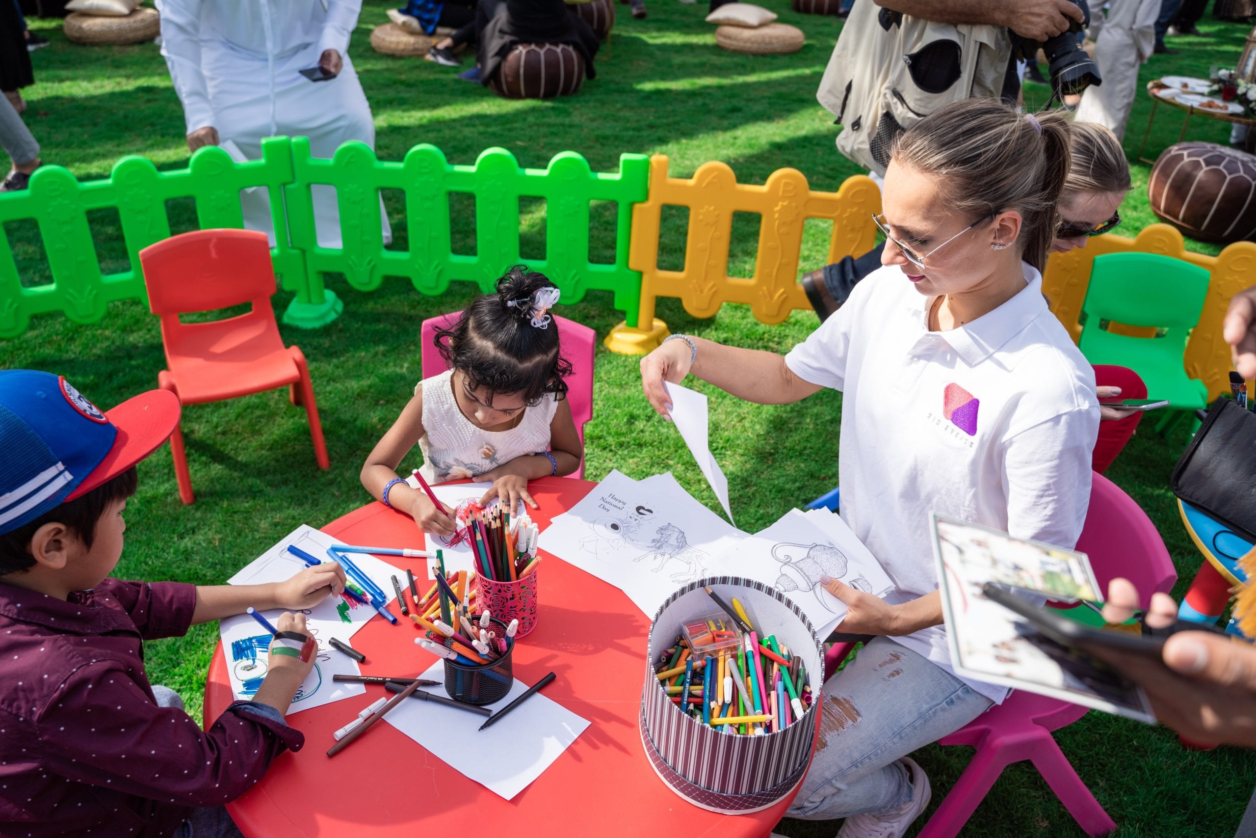 woman and children painting in the park, outdoor events | community events